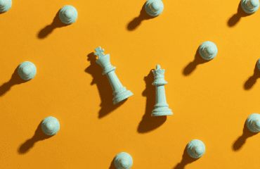 chess pieces on orange plain background