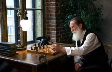 an old man playing chess by himself