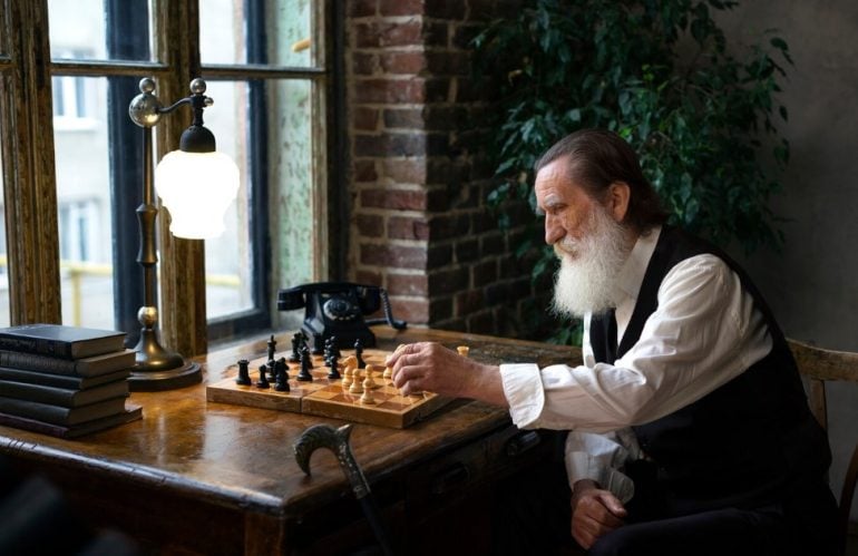 an old man playing chess by himself