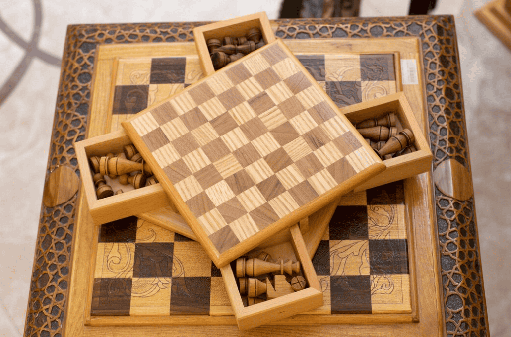 wooden chess set with intricately designed storage compartments and pieces